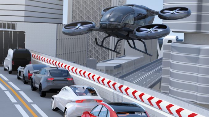 Black,Passenger,Drone,Flying,Over,Cars,In,Heavy,Traffic,Jam.